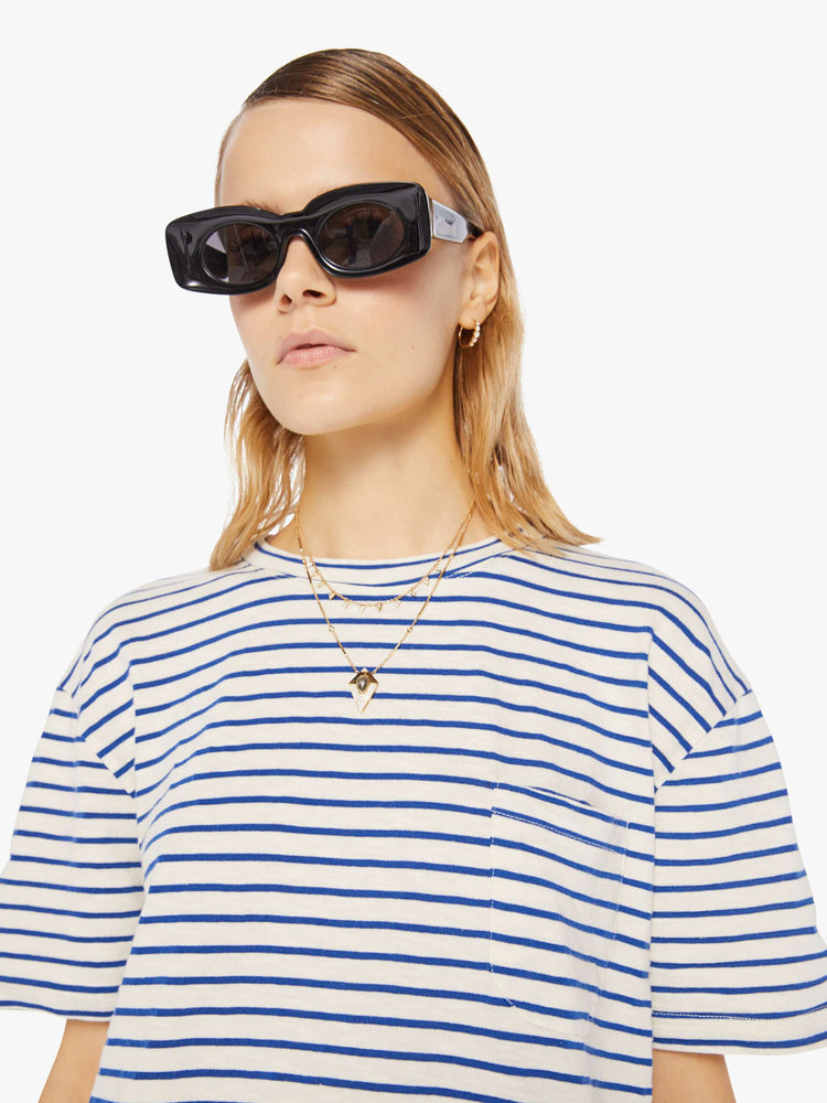 Front close up view of a womens white crew neck tee with blue stripes and an oversized fit.