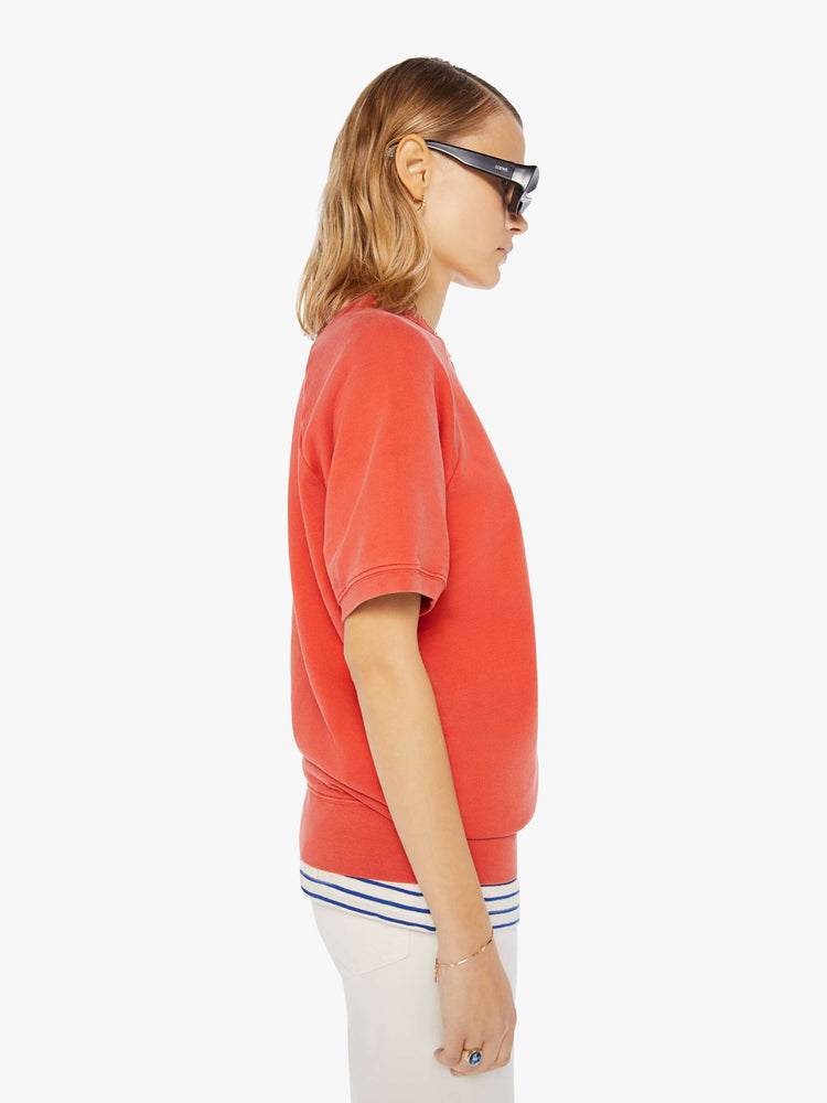 Side view of a womens red short sleeve sweatshirt featuring raglan sleeves.