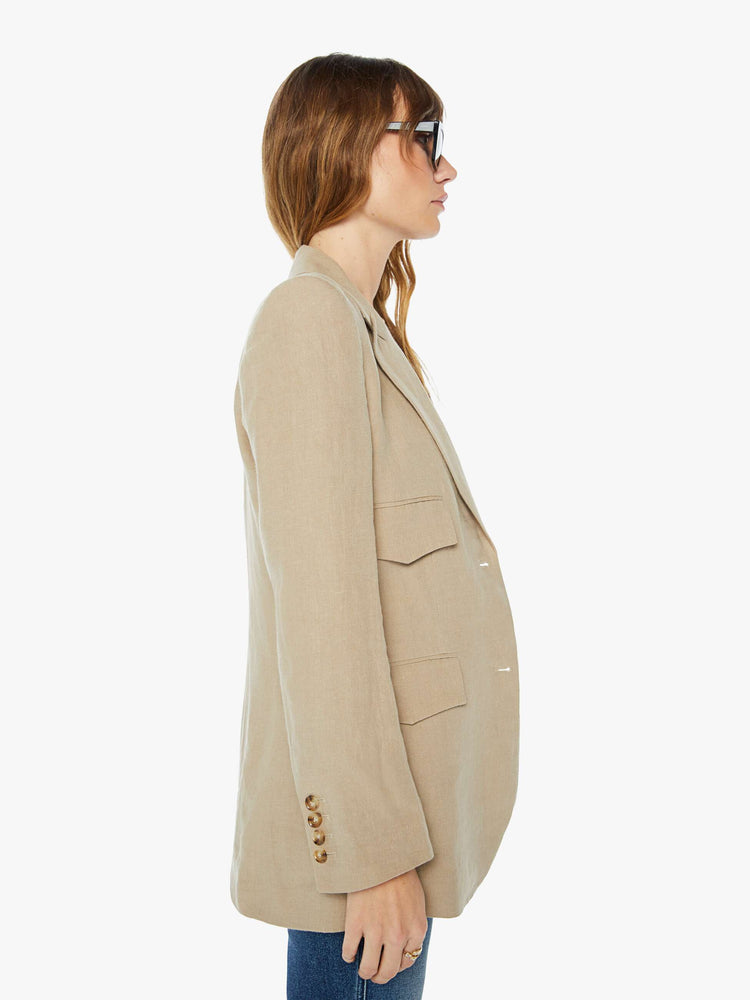 Side view of a womens tank blazer featuring two buttons and four front pockets.