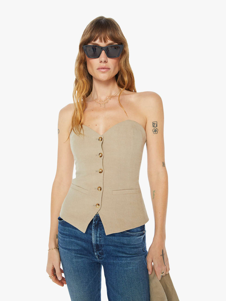 Front view of a womens tan bustier top with suit details.