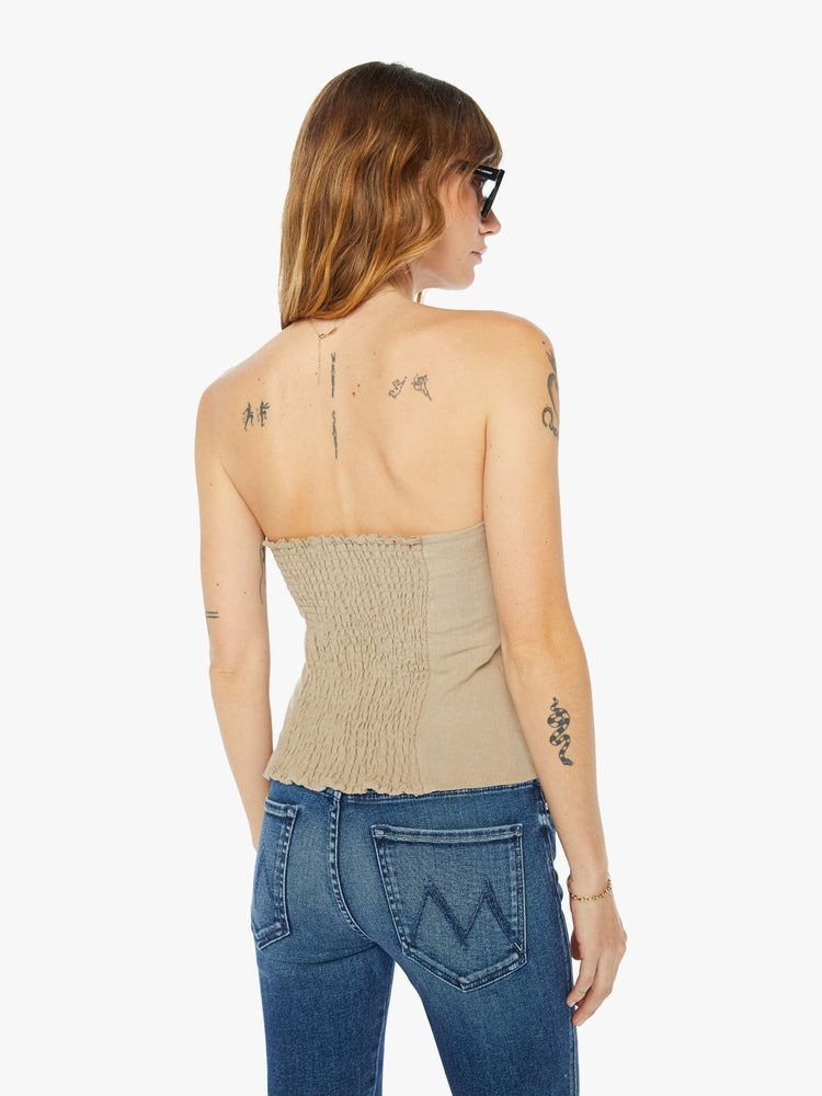 Back view of a womens tan bustier top with suit details.