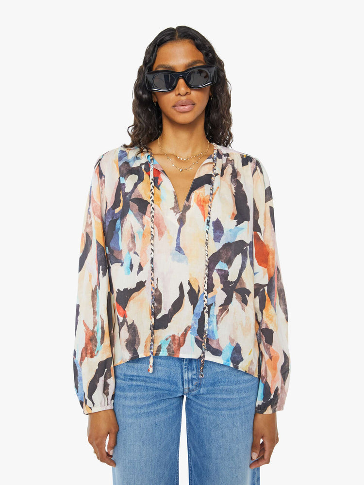 Front view of a womens long sleeve blouse featuring a v neck with two strands.