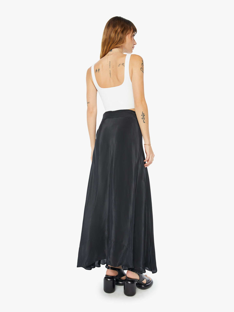 Back view of a womens black wrap skirt featuring a high waist.