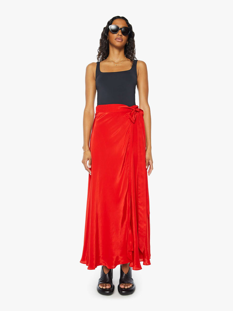 Front view of a womens red wrap skirt featuring a high waist.