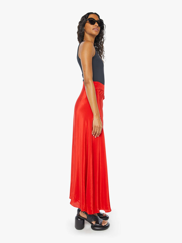 Side view of a womens red wrap skirt featuring a high waist.
