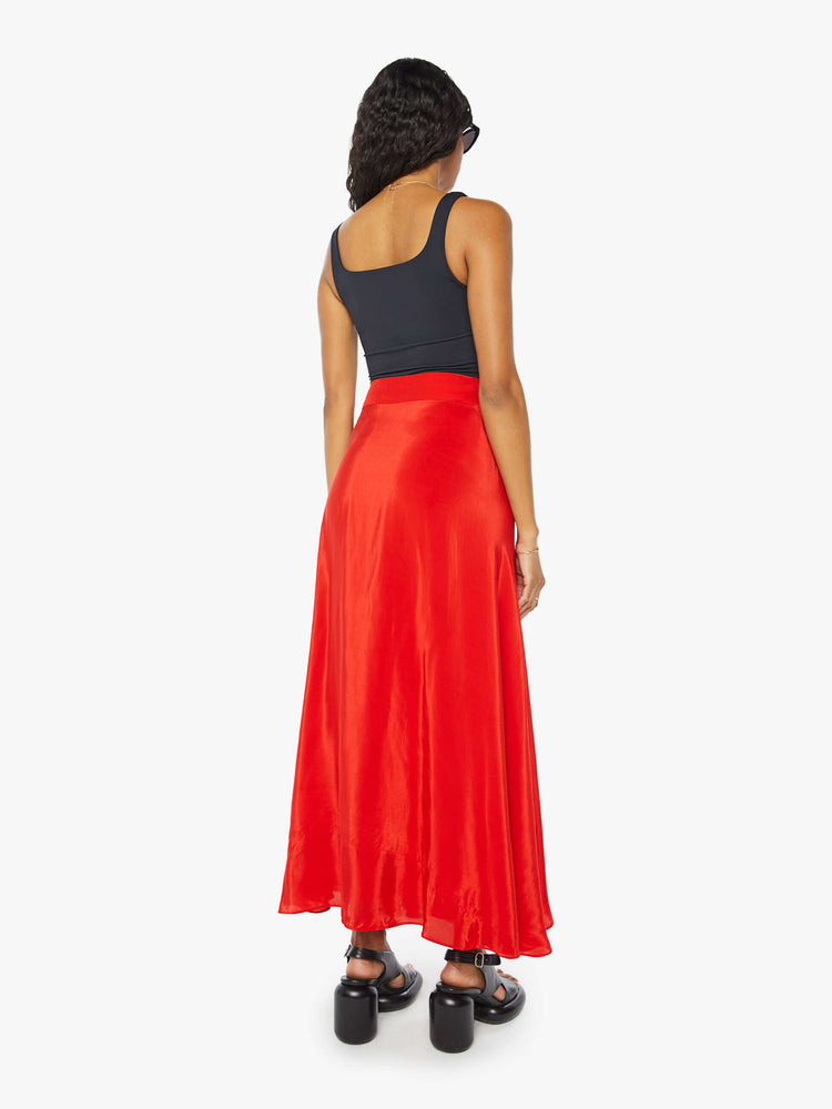 Back view of a womens red wrap skirt featuring a high waist.