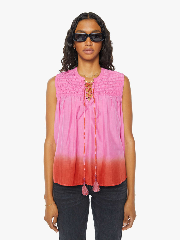 Front view of a womens sleeveless top featuring a v neck with tassels.