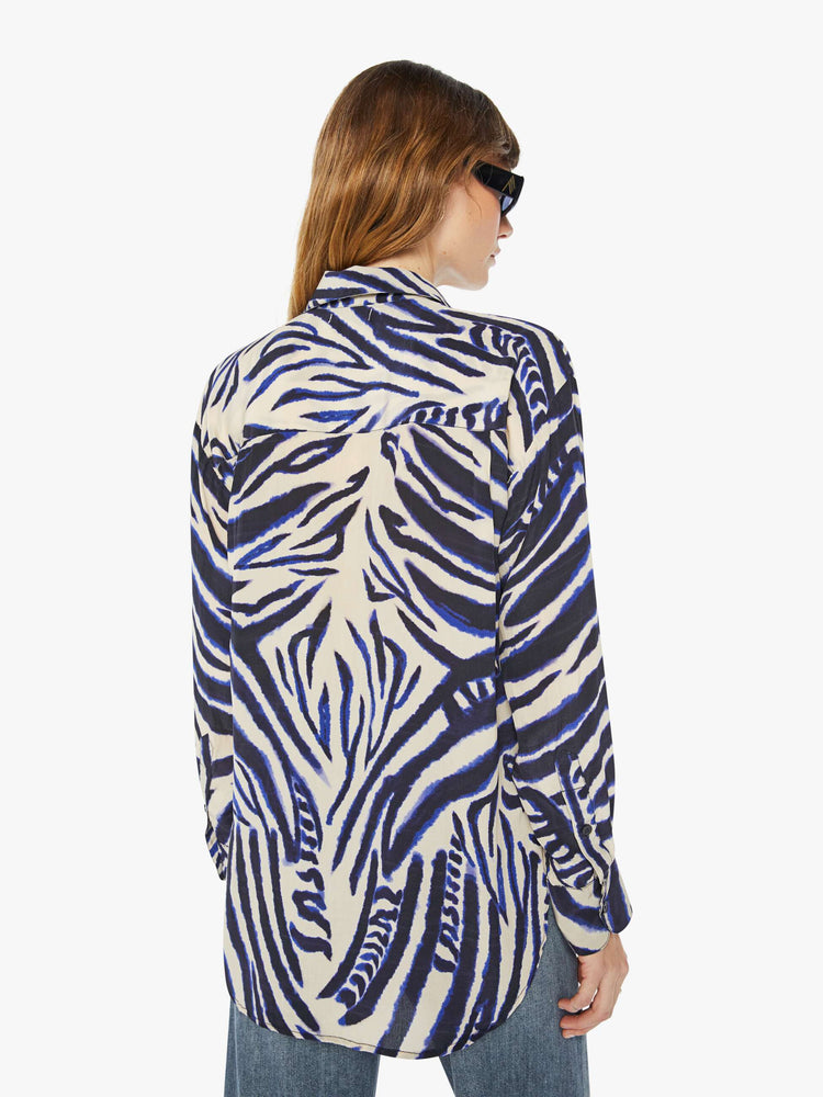 Back view of a womens long sleeve button down shirt featuring a zebra animal print.