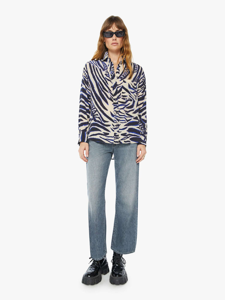 Front full body view of a womens long sleeve button down shirt featuring a zebra animal print.