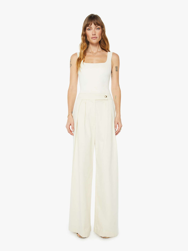 Front view of a womens off white pant featuring a high rise, a pleated wide leg, and long inseam.