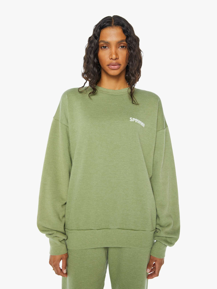Front view of a  womens green crew neck sweatshirt featuring a relaxed fit and SPRWMN printed on the chest.