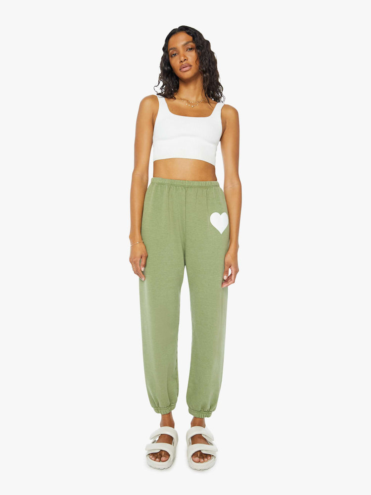 Front view of a womens green sweatpant featuring an elastic waist and a white heart printed on the hip.