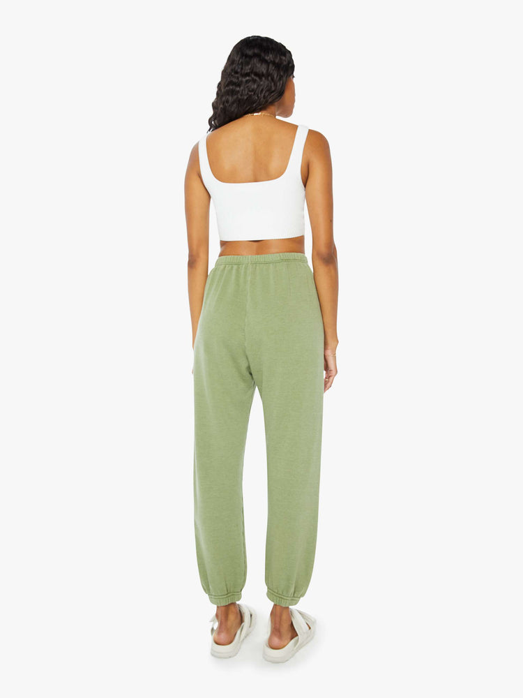 Back view of a womens green sweatpant featuring an elastic waist and a white heart printed on the hip.