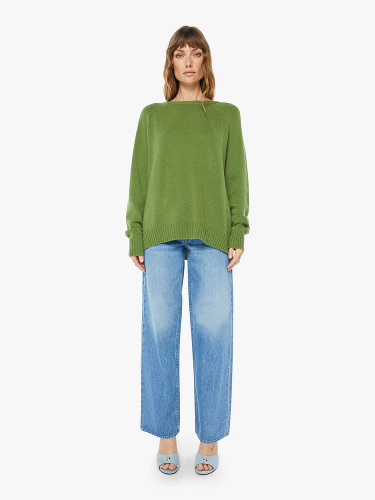 Front full body view of a  womens green crew neck knit sweater featuring an oversized fit.