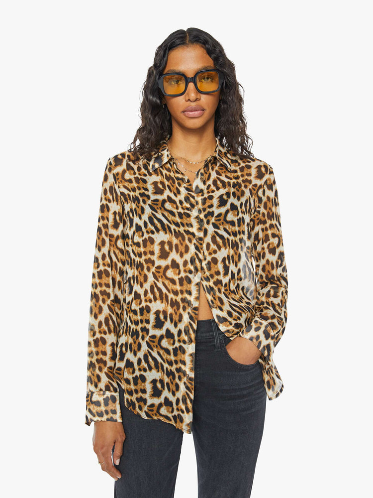 Front view of a womens sheer button down shirt featuring a leopard print.