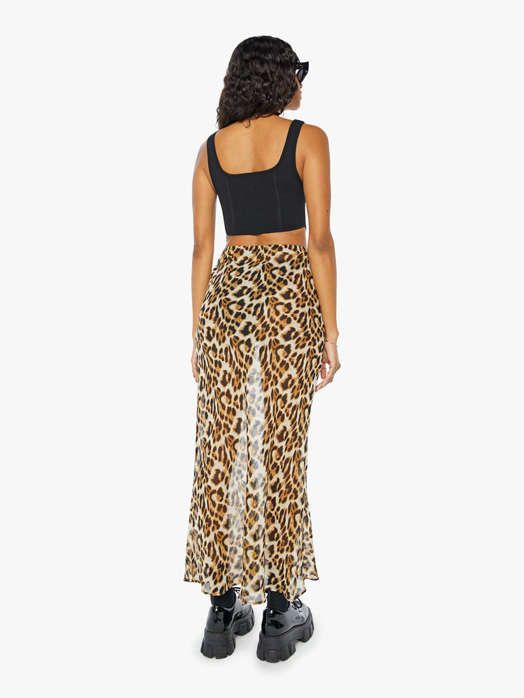 Back view of a womens sheer maxi skirt featuring a leopard print and high rise.