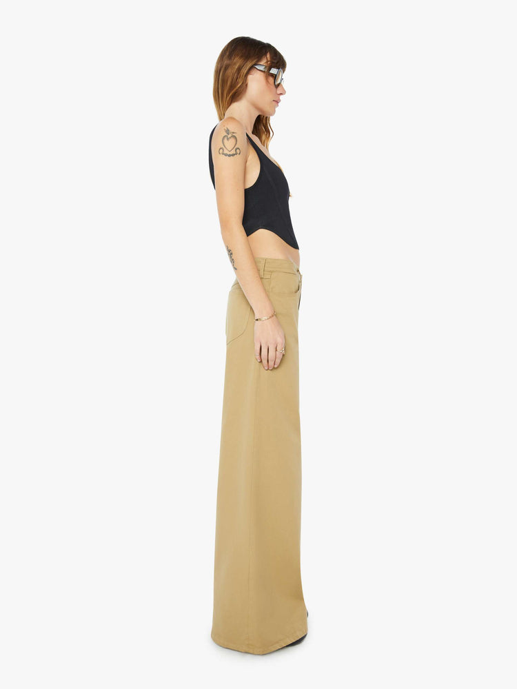 Side view of a womens brown pant featuring a relaxed mid rise and wide leg.