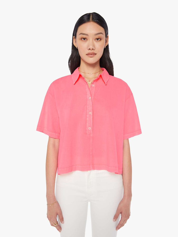 Front view of a womens neon pink collar shirt featuring a 3/4 length button, dropped short sleeves, and a cropped boxy fit.