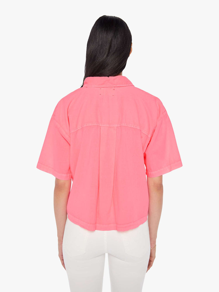 Back view of a womens neon pink collar shirt featuring a 3/4 length button, dropped short sleeves, and a cropped boxy fit.