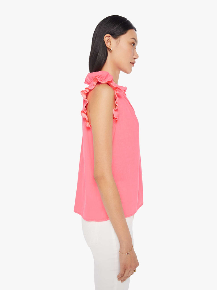 Side view of a womens neon pink blouse featuring sleeveless ruffles and a v neck.