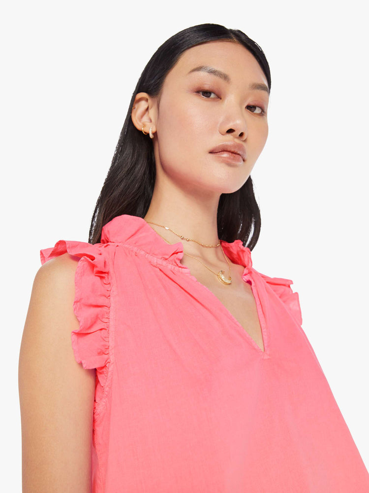 Front close up view of a womens neon pink blouse featuring sleeveless ruffles and a v neck.
