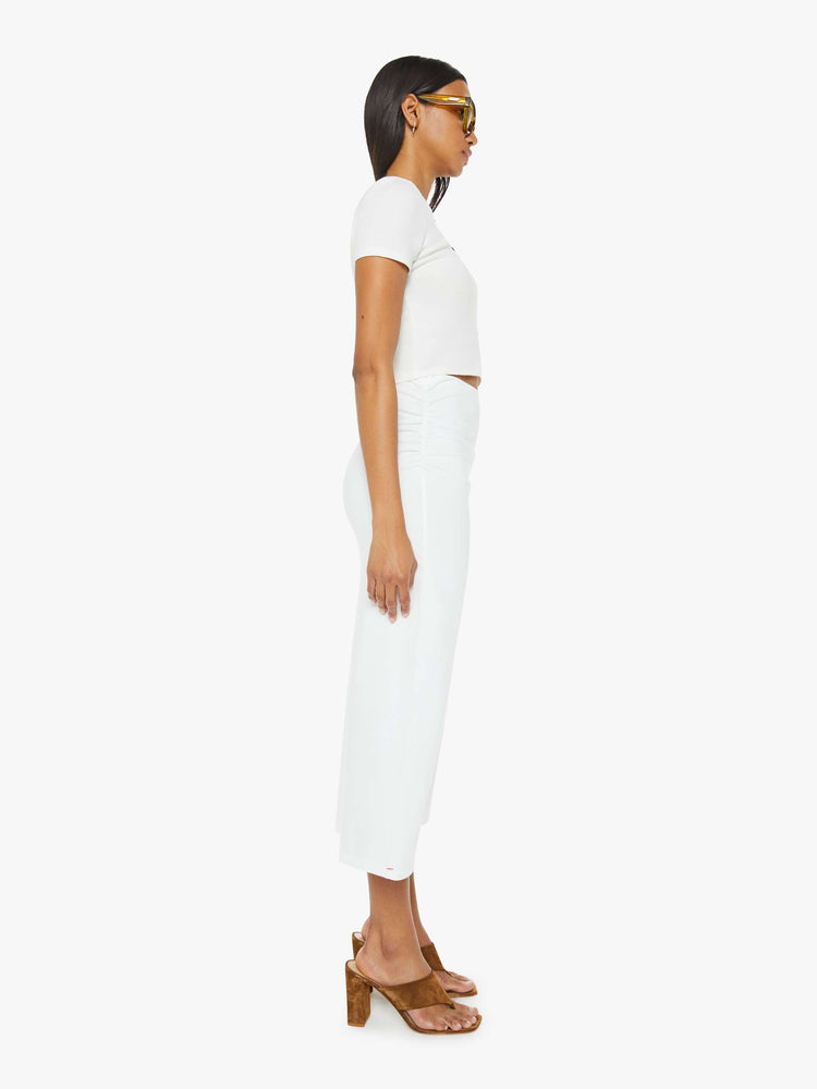 Side view of women maxi skirt in white, the Lenny skirt features a high rise, gathered waist and a slightly narrow fit.