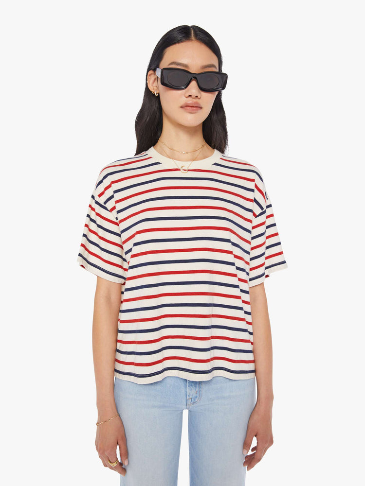 Front view of a woman wearing a boxy t-shirt with red, white, and blue stripes