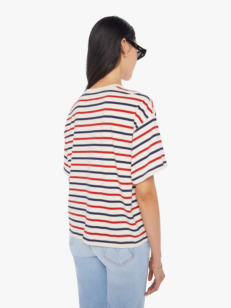 Back view of a woman wearing a boxy t-shirt with red, white, and blue stripes