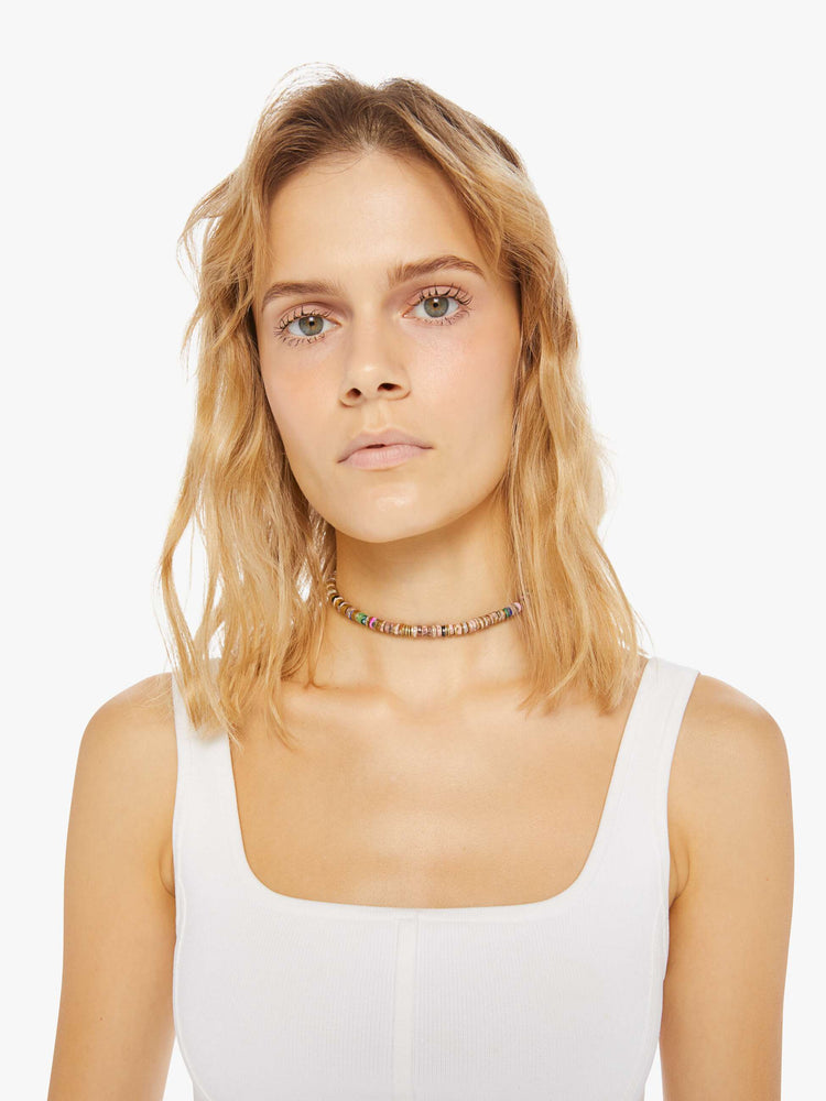 Front view of a woman wearing a beaded necklace on a tan vegan suede cord