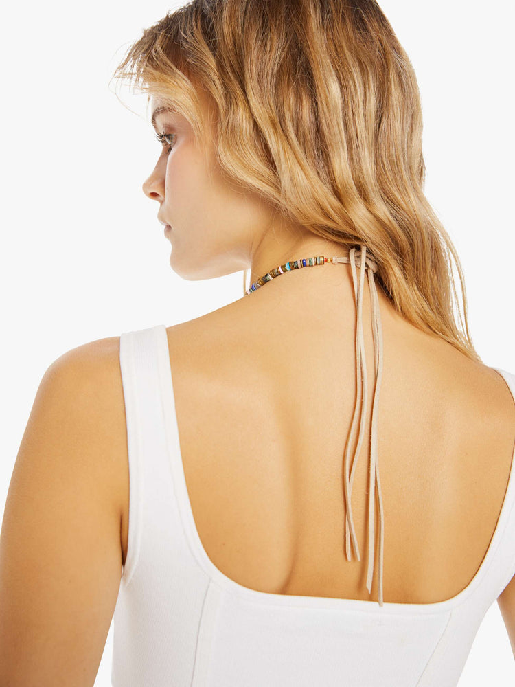 Back view of a woman wearing a beaded necklace on a tan vegan suede cord