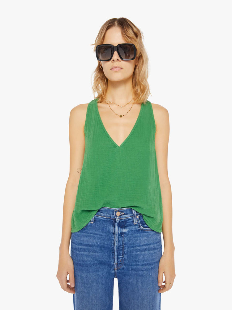 Front view of a womens green top featuring a deep v neck and a loose boxy fit.