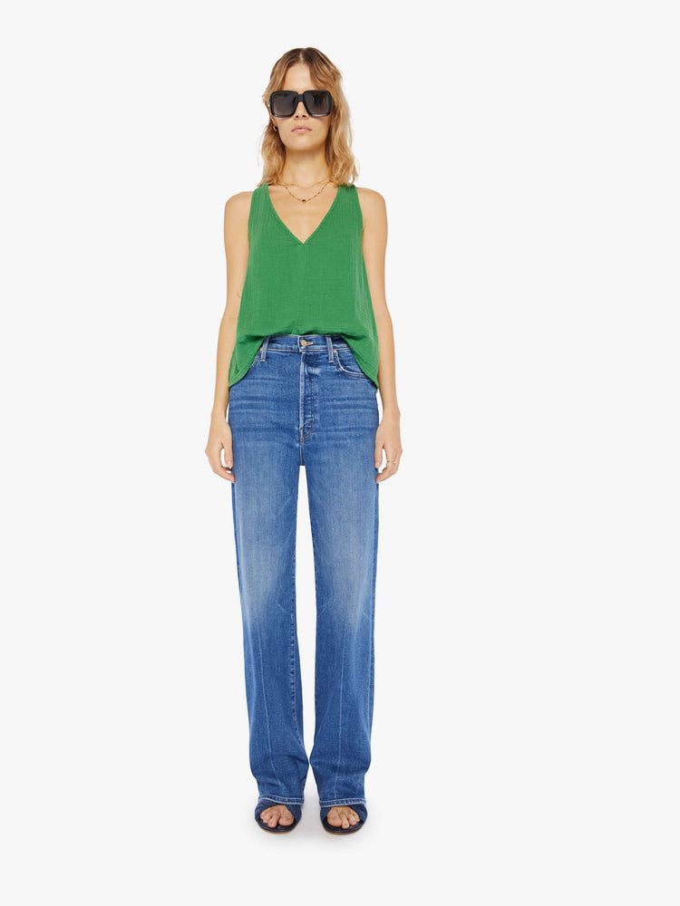 Front full body view of a womens green top featuring a deep v neck and a loose boxy fit.