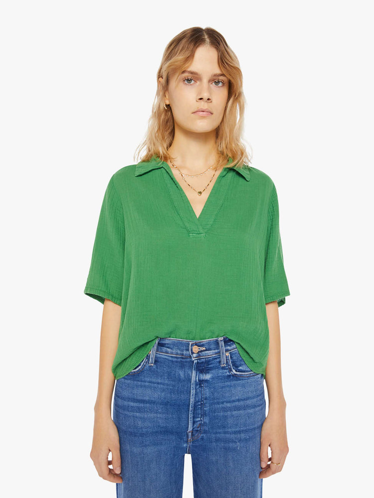 Front view of a womens green top featuring a v neck collar, 3/4 short sleeves, and a boxy cropped fit.