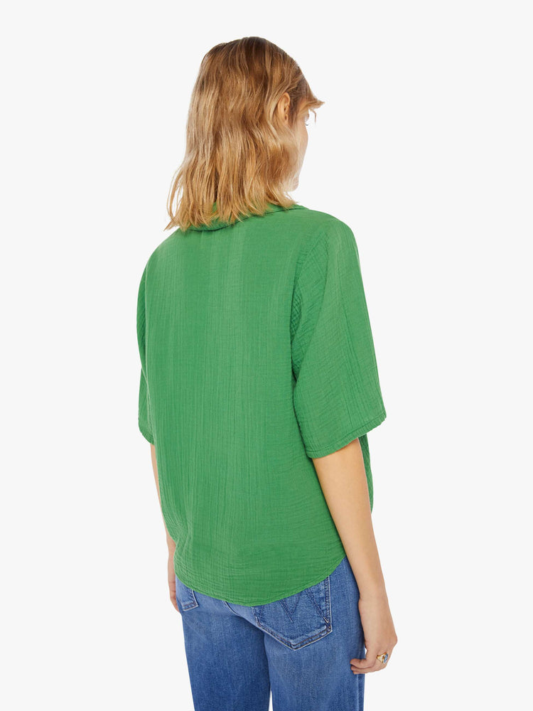 Back view of a womens green top featuring a v neck collar, 3/4 short sleeves, and a boxy cropped fit.