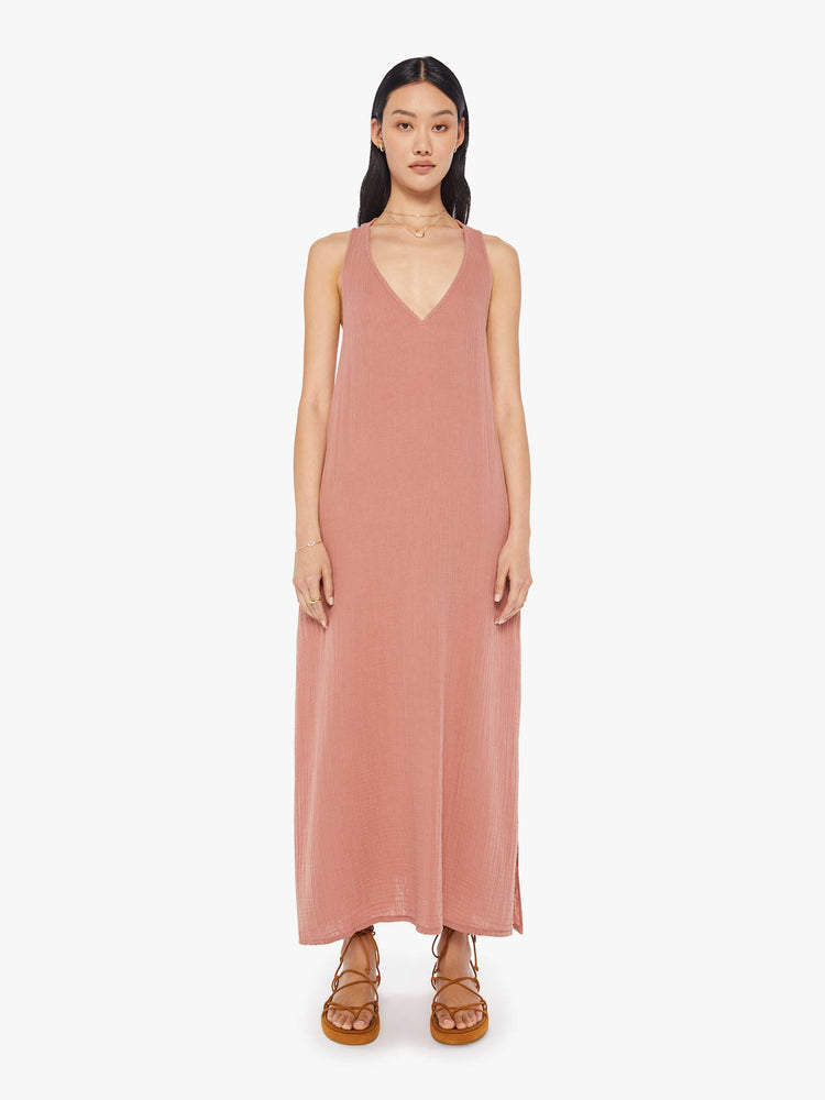 Front view of a womens dusty pink, ankle length dress featuring a deep v neck and a loose fit.