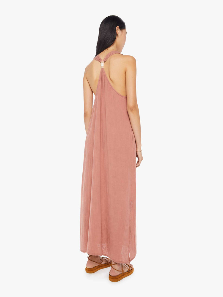 Back view of a womens dusty pink, ankle length dress featuring a deep v neck and a loose fit.