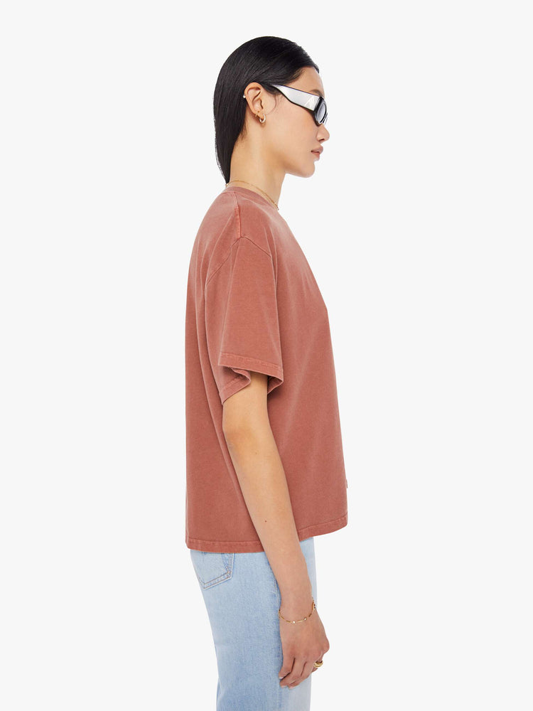Side view of a womens warm brown tee featuring dropped short sleeves and a boxy fit.