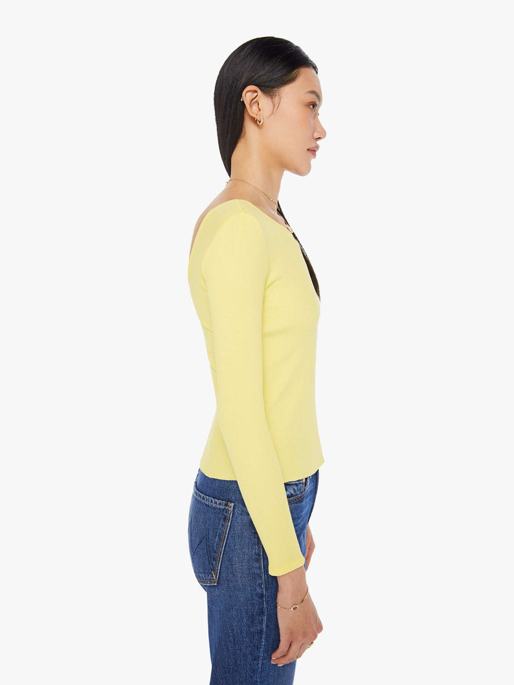Side view of a womens light yellow fitted long sleeve tee featuring a scoop neck.