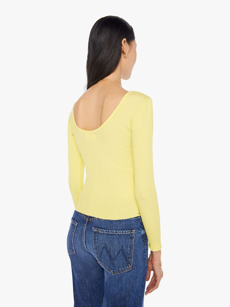Back view of a womens light yellow fitted long sleeve tee featuring a scoop neck.