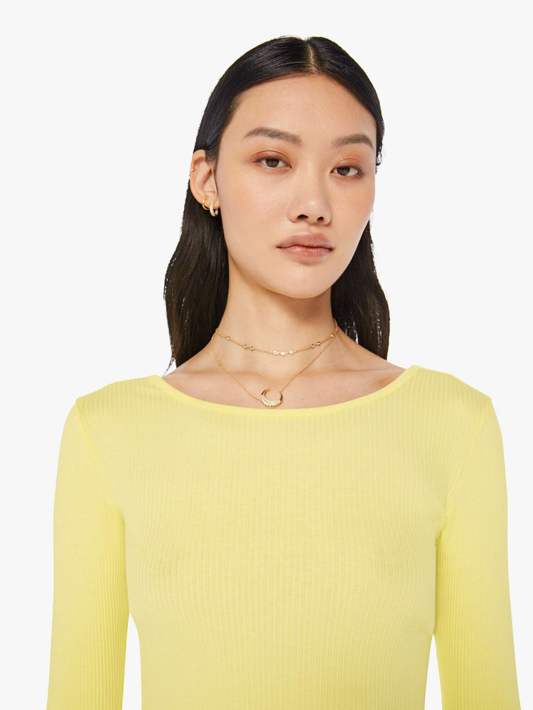 Front close up view of a womens light yellow fitted long sleeve tee featuring a scoop neck.