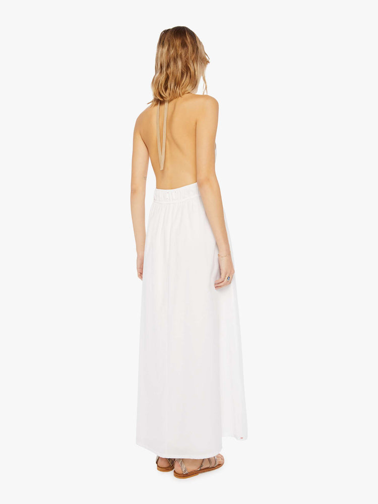 Back view of a womens white ankle length dress featuring a deep v halter neck and a full skirt.