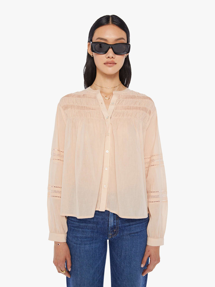 Front view of a womens light brown button down blouse featuring eyelet lace details and a slightly balloon long sleeve.