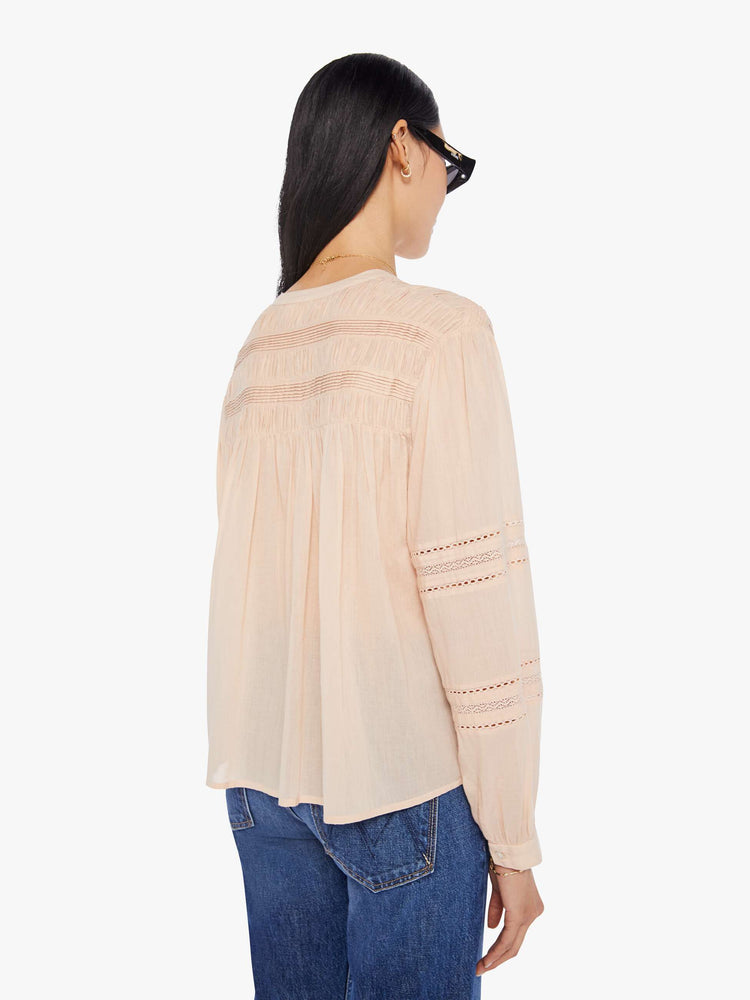 Back view of a womens light brown button down blouse featuring eyelet lace details and a slightly balloon long sleeve.