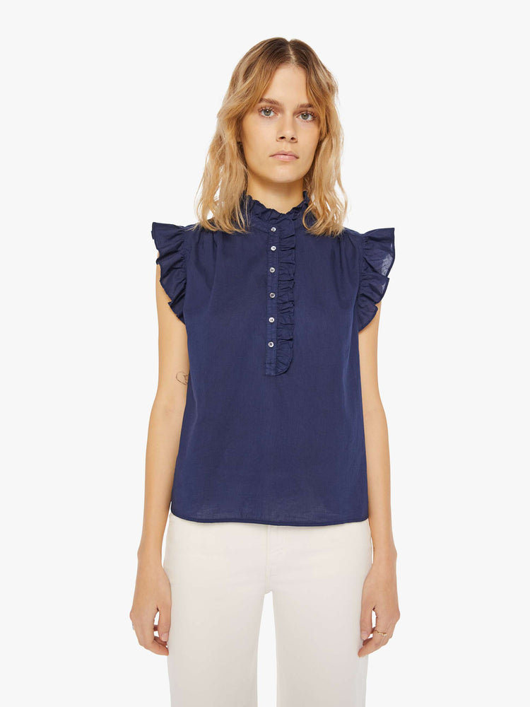 Front view of a navy blue blouse featuring a ruffled mock neck and sleeveless ruffles.