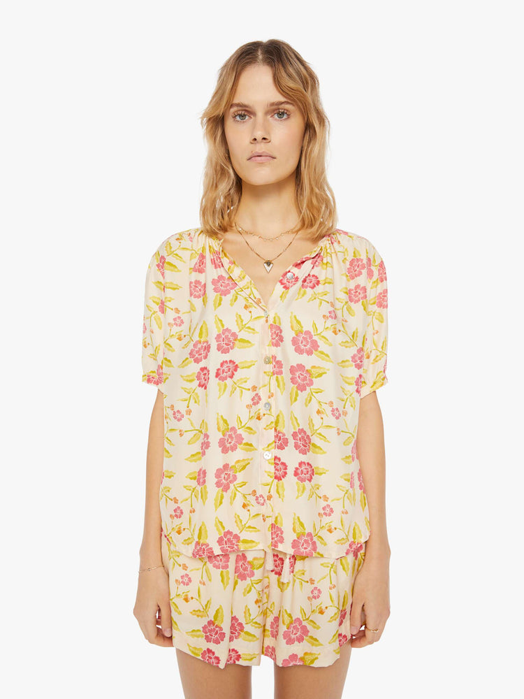 Front view of a womens short sleeve button down blouse, featuring short sleeves and a floral print.