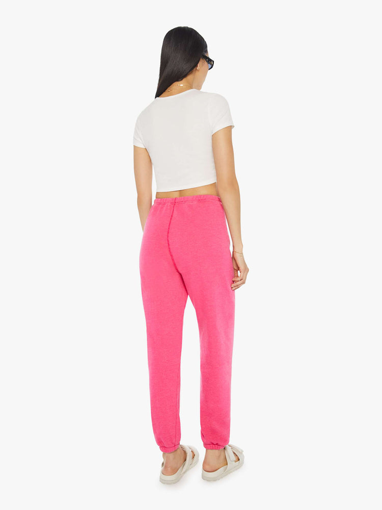 Back view of a womens hot pink sweatpant featuring a white heart graphic.