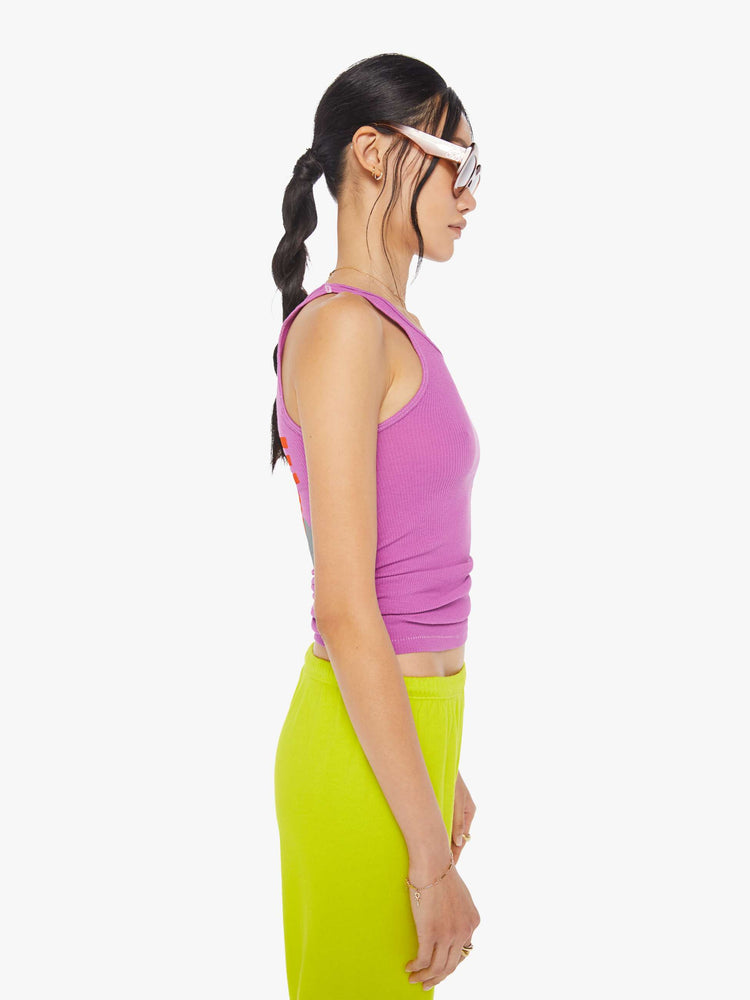 Side view of a woman wearing a pink tank.