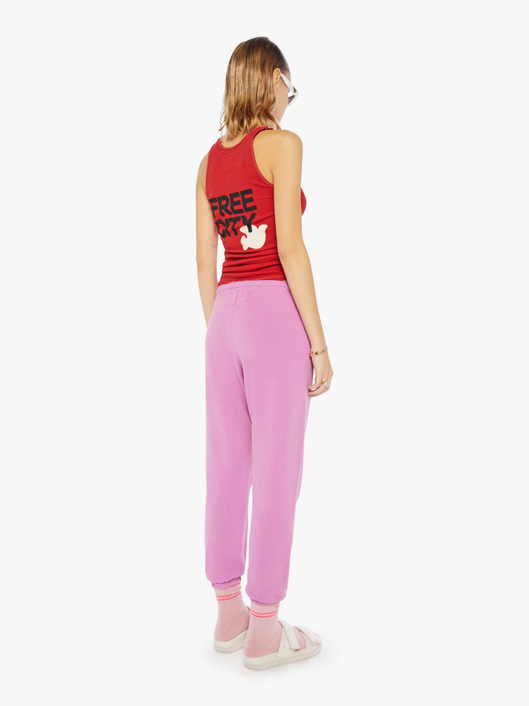 Back view of a woman wearing pink sweatpants and a red tank.