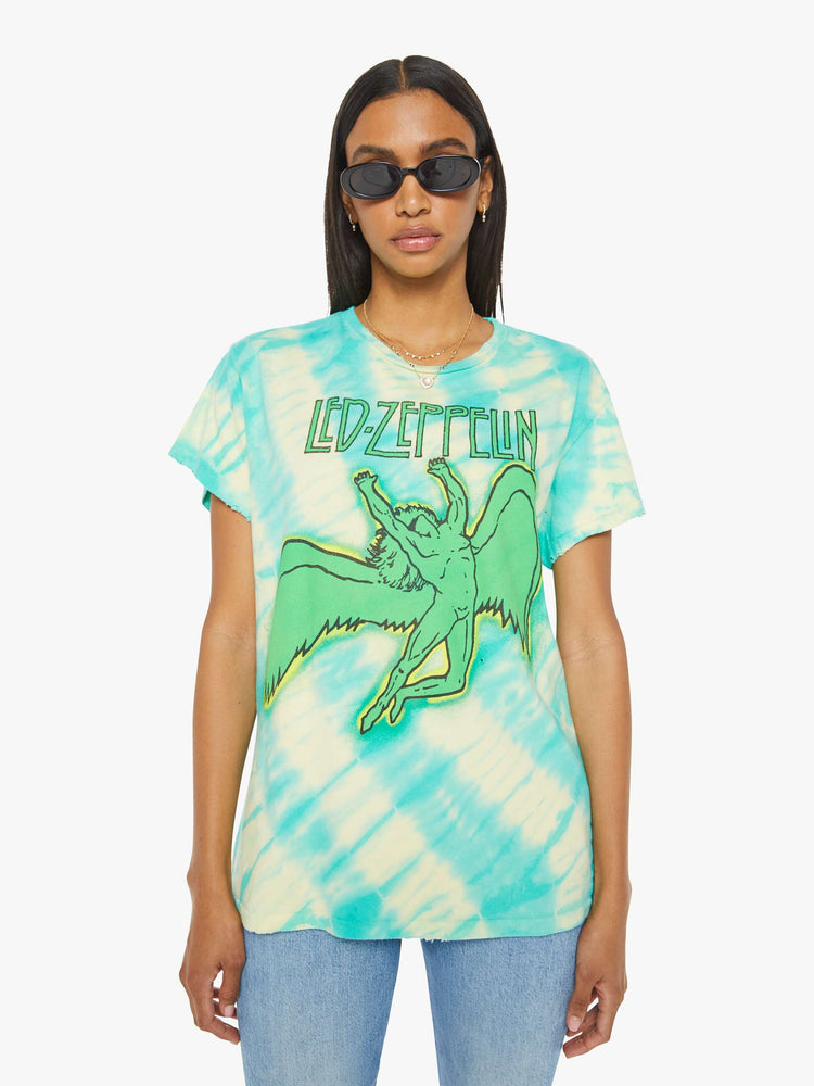 Front view of a woman in crewneck that pays homage to Led Zeppelin with a green Icarus graphic on the front.