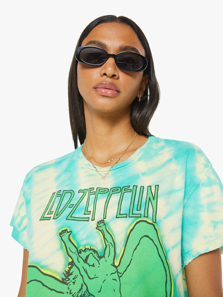 Close up view of a woman in crewneck that pays homage to Led Zeppelin with a green Icarus graphic on the front.